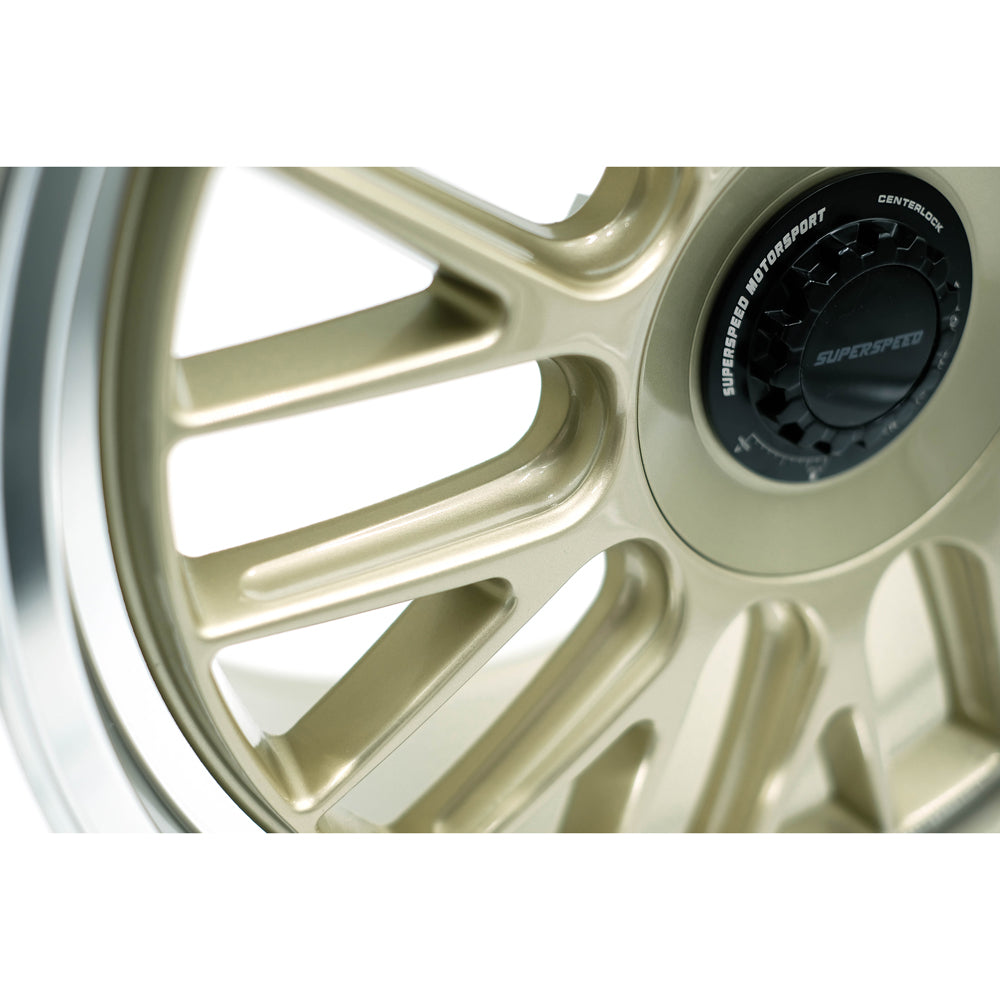 Gold alloy wheel with a Superspeed brand logo on a white background