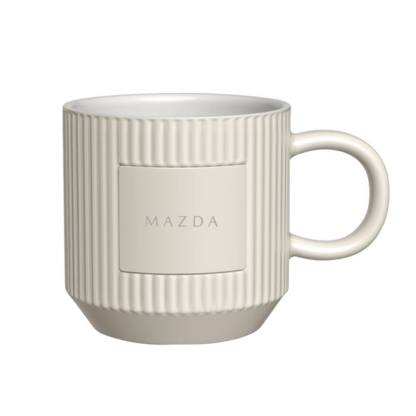 Beige mug with Mazda logo on a white background