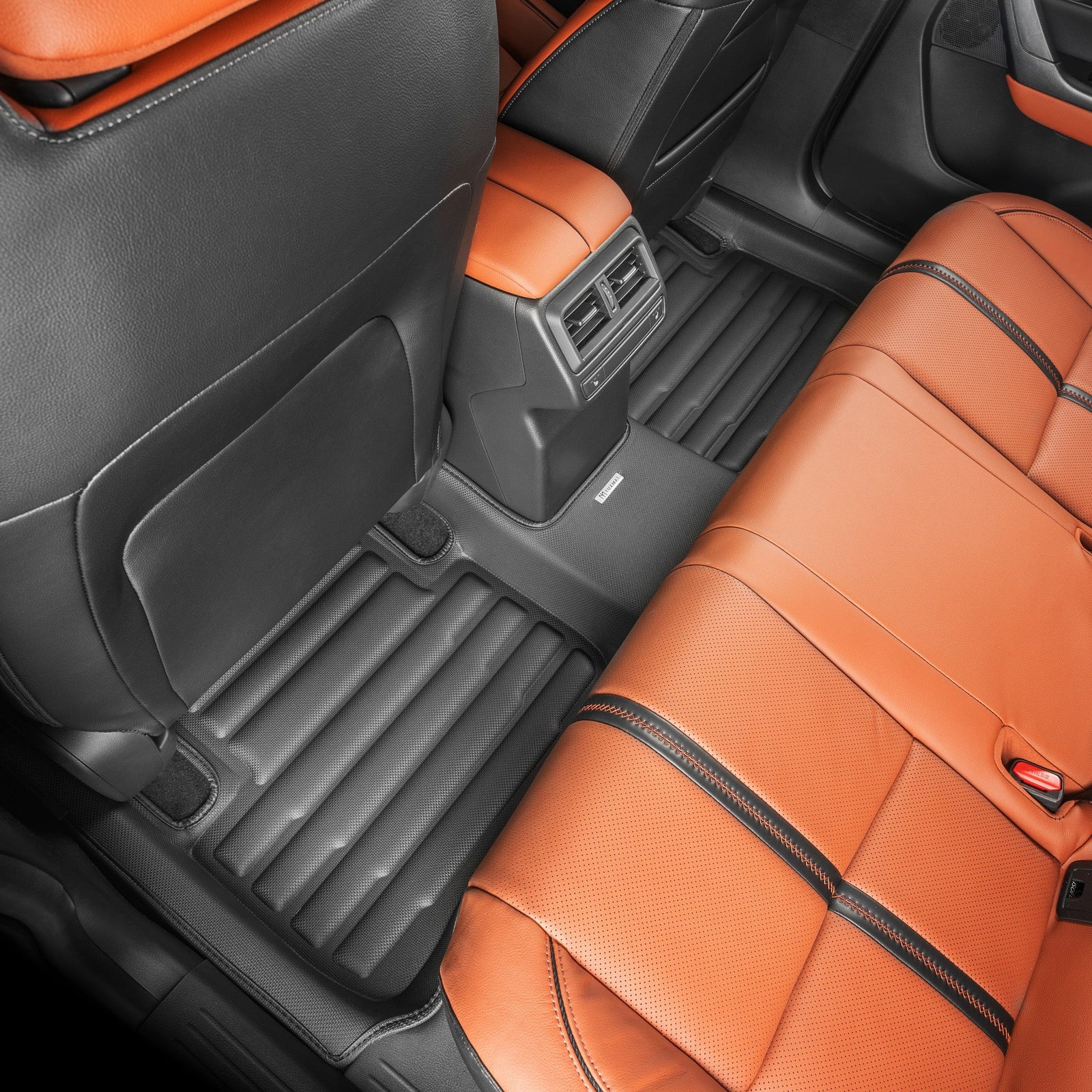 Close-up of a car's interior with orange and black seats.
