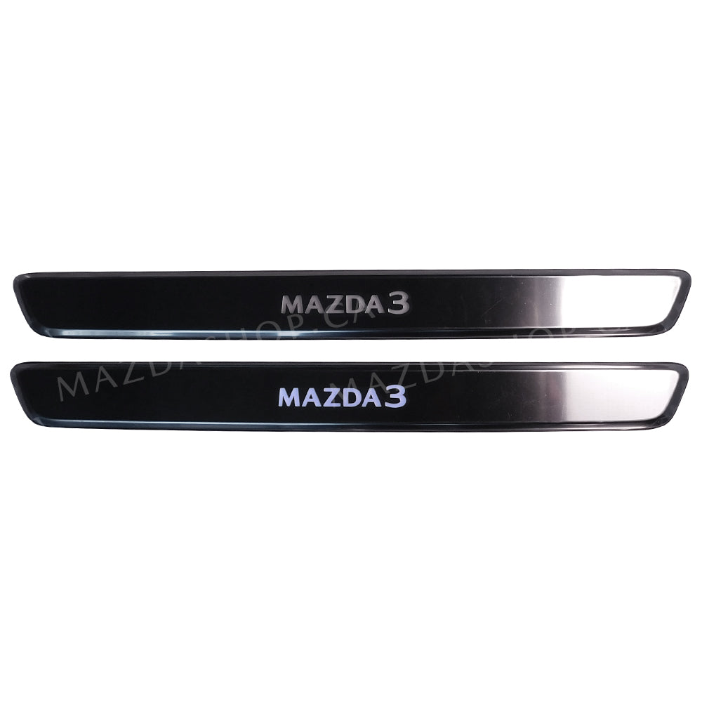 Two metallic car door sill protectors with 'MAZDA 3' branding on a white background.
