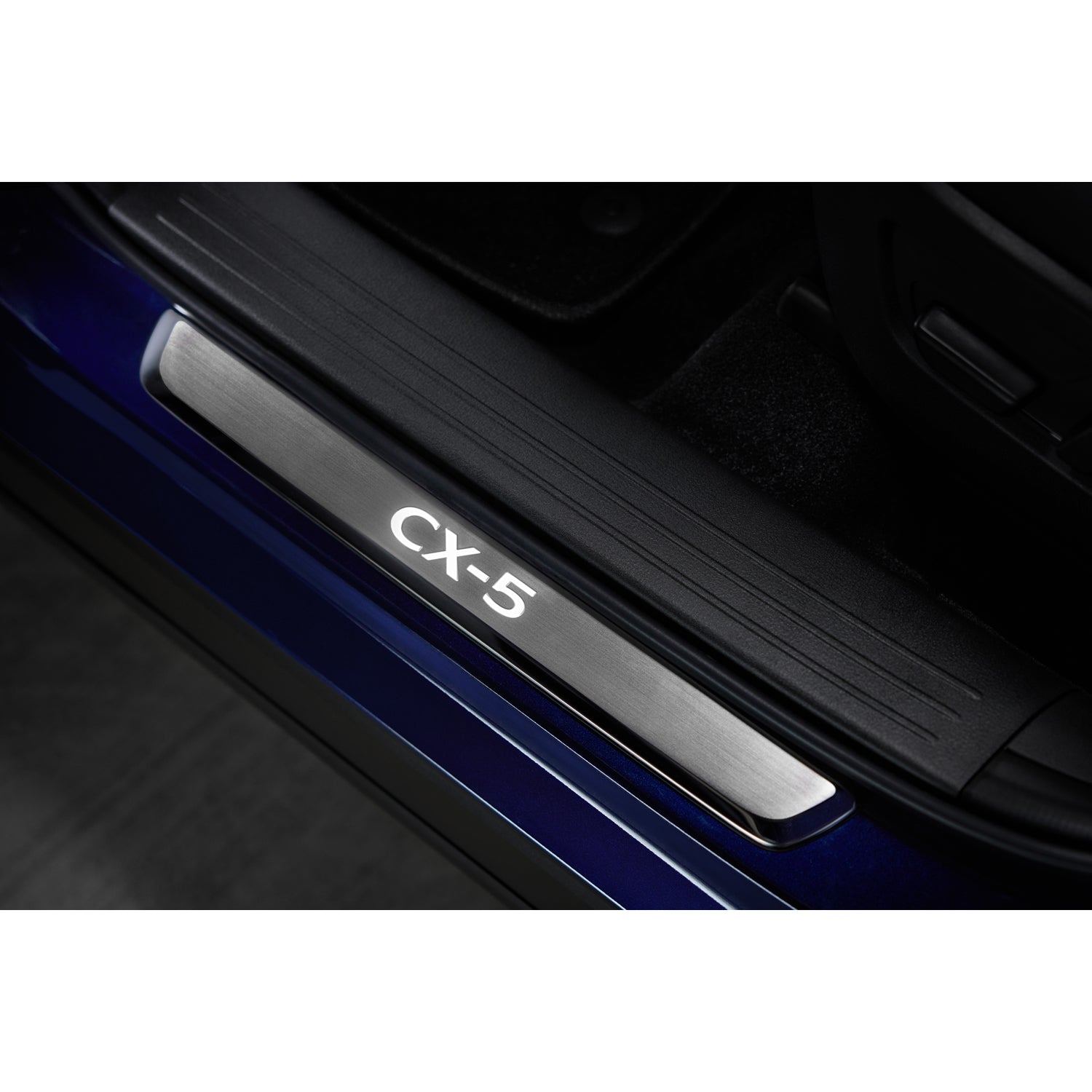 Silver Door Sill Trim Plate with illuminated CX-5 logo on blue vehicle