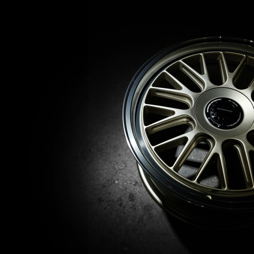 Close-up of a car wheel rim with a dark background